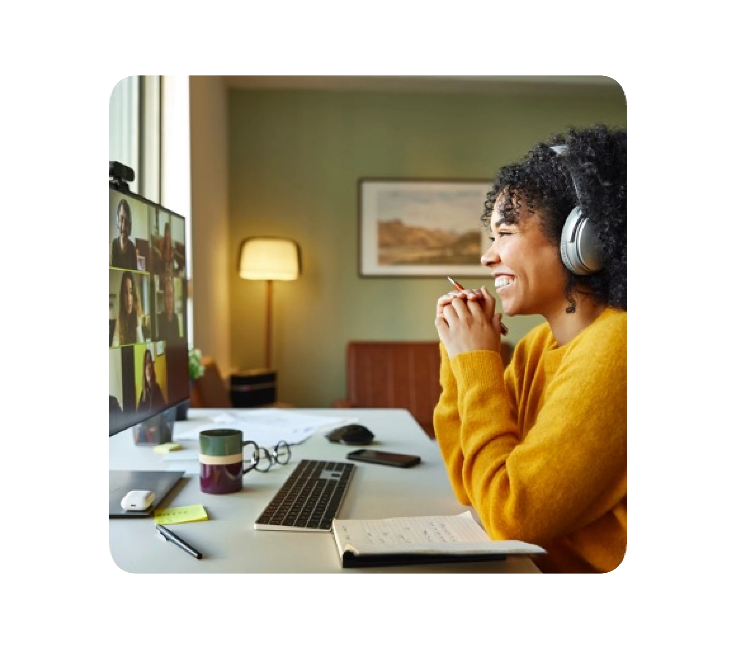 woman watching laptop screen and smiling